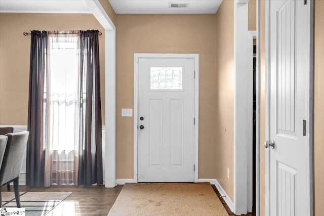 entrance foyer featuring visible vents, baseboards, and wood finished floors