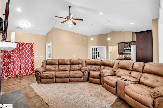 living area featuring visible vents, high vaulted ceiling, a ceiling fan, and dark wood-style floors