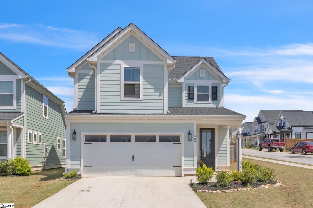 309 Townsend Ave, Greer, SC 29651 - view of front of home with board and batten siding, driveway, and a garage