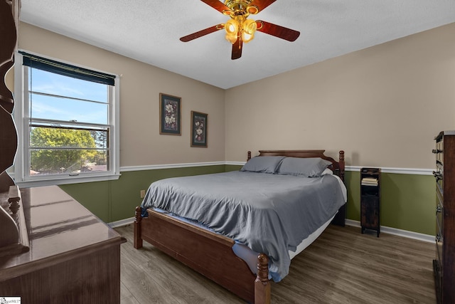 407 Rotterdam Rd, Easley, SC 29640 - bedroom featuring a textured ceiling, wood finished floors, baseboards, and a ceiling fan