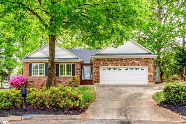15 Red Cedar Ct, Simpsonville, SC 29681 - view of front of property featuring roof with shingles, driveway, a garage, and brick siding