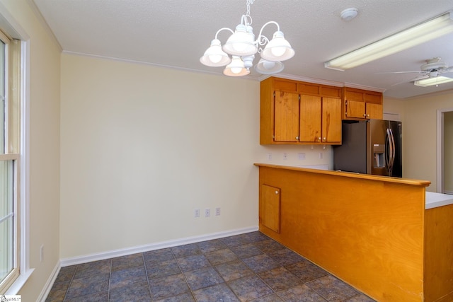 15 Red Cedar Ct, Simpsonville, SC 29681 - kitchen featuring brown cabinetry, a peninsula, light countertops, stainless steel fridge, and baseboards