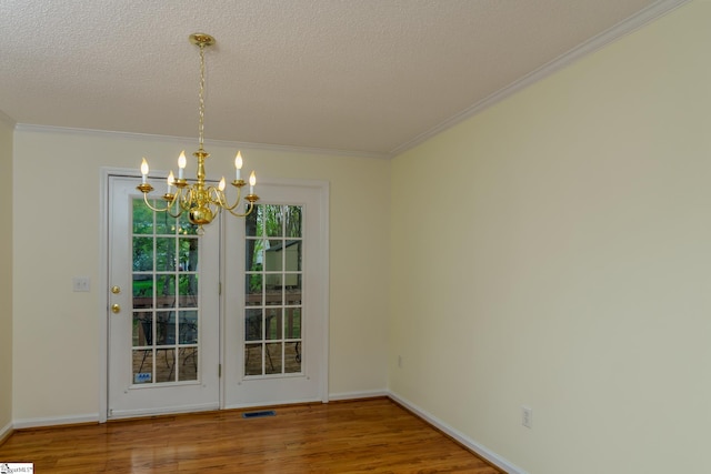 15 Red Cedar Ct, Simpsonville, SC 29681 - unfurnished dining area featuring visible vents, an inviting chandelier, ornamental molding, and wood finished floors