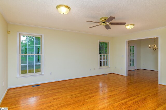 15 Red Cedar Ct, Simpsonville, SC 29681 - spare room featuring visible vents, baseboards, light wood-type flooring, a textured ceiling, and ceiling fan with notable chandelier