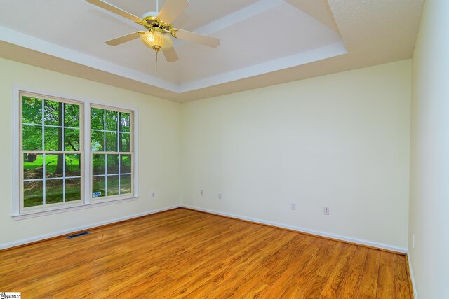 15 Red Cedar Ct, Simpsonville, SC 29681 - empty room featuring light wood-type flooring, baseboards, a raised ceiling, visible vents, and ceiling fan