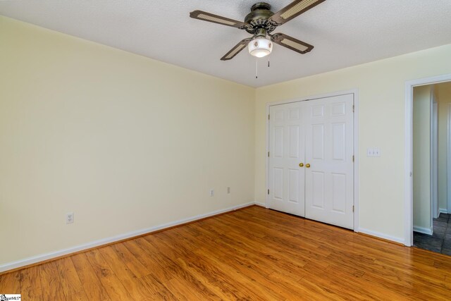 15 Red Cedar Ct, Simpsonville, SC 29681 - unfurnished bedroom with a closet, baseboards, a ceiling fan, and wood finished floors