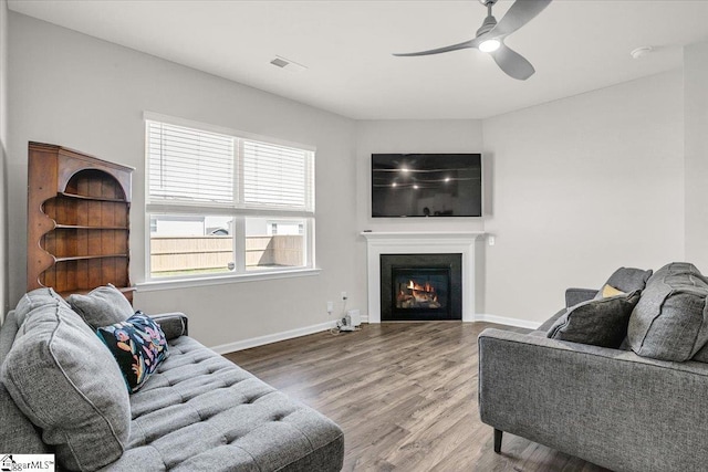 103 Slateford Cir, Piedmont, SC 29673 - living room with visible vents, baseboards, a warm lit fireplace, ceiling fan, and wood finished floors