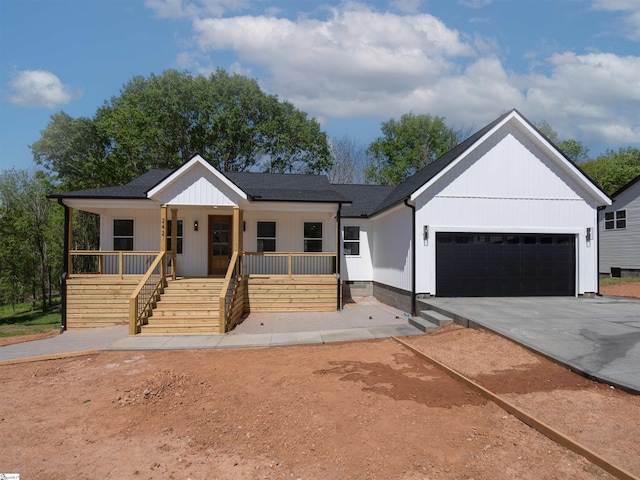 242 Queensbury Way, Spartanburg, SC 29302 - modern inspired farmhouse with a garage, a porch, stairs, and concrete driveway