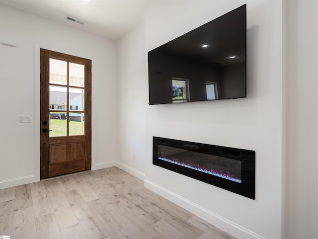 242 Queensbury Way, Spartanburg, SC 29302 - foyer with a glass covered fireplace, light wood-style floors, baseboards, and visible vents