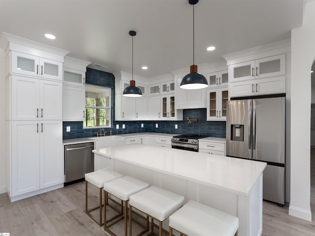242 Queensbury Way, Spartanburg, SC 29302 - kitchen with light wood-style flooring, white cabinetry, light countertops, stainless steel appliances, and backsplash