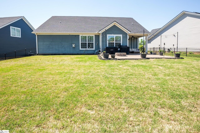 rear view of property featuring a yard, a patio, and fence private yard
