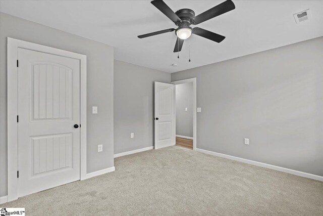 unfurnished bedroom with carpet flooring, visible vents, baseboards, and ceiling fan