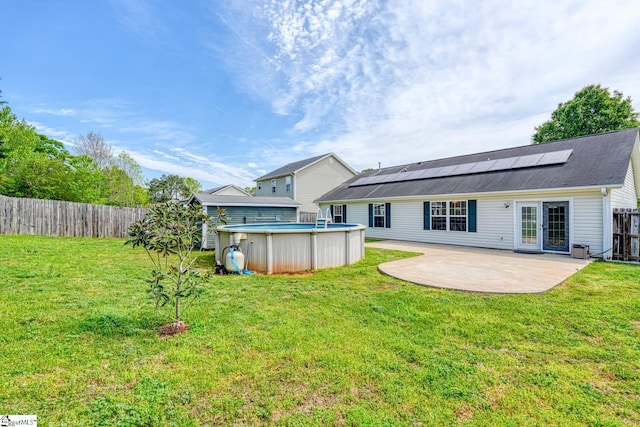 611 Grover Dr, Lyman, SC 29365 - rear view of house featuring a fenced backyard, solar panels, a patio, and a lawn