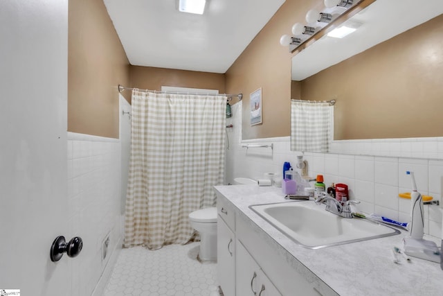 4150 Sandy Flat Rd, Taylors, SC 29687 - bathroom with vanity, tile patterned floors, toilet, wainscoting, and tile walls