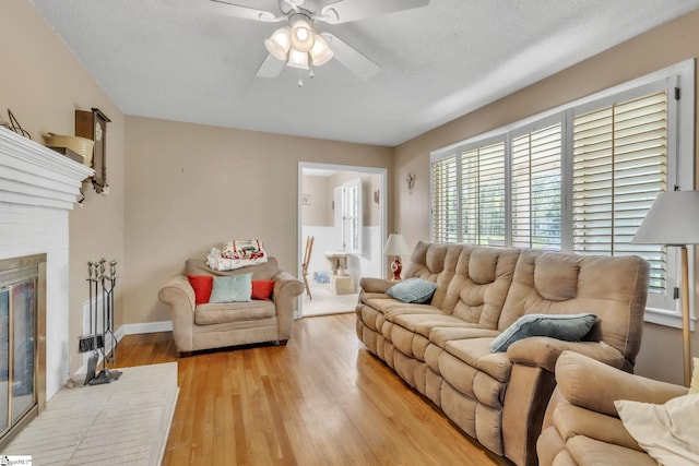 4150 Sandy Flat Rd, Taylors, SC 29687 - living room with baseboards, a ceiling fan, a brick fireplace, and light wood finished floors