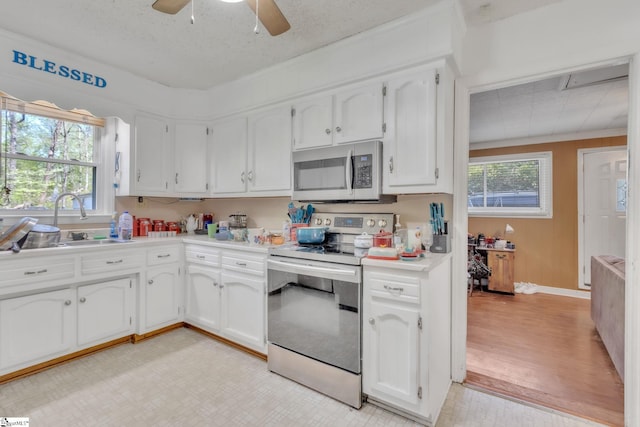 4150 Sandy Flat Rd, Taylors, SC 29687 - kitchen featuring white cabinets, a healthy amount of sunlight, a sink, and appliances with stainless steel finishes
