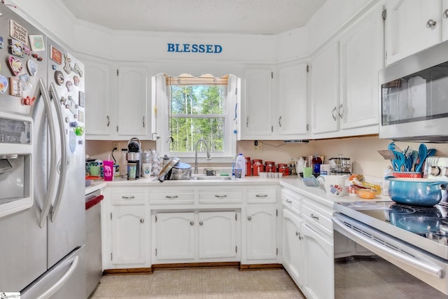 4150 Sandy Flat Rd, Taylors, SC 29687 - kitchen with a sink, white refrigerator with ice dispenser, white cabinetry, and stainless steel microwave