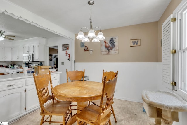 4150 Sandy Flat Rd, Taylors, SC 29687 - dining space with light tile patterned floors and ceiling fan with notable chandelier