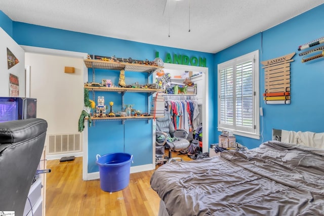 4150 Sandy Flat Rd, Taylors, SC 29687 - bedroom with a textured ceiling, wood finished floors, a closet, and visible vents