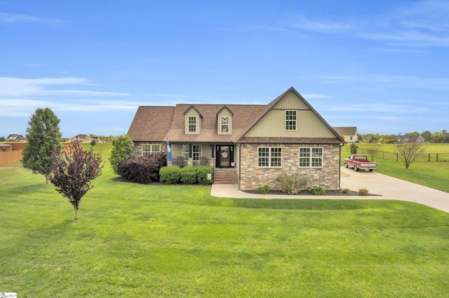 view of front facade featuring concrete driveway, stone siding, and covered porch