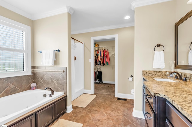 full bath featuring crown molding, vanity, a shower stall, a garden tub, and a walk in closet