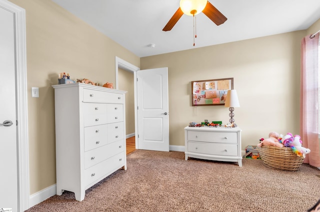 carpeted bedroom featuring baseboards and a ceiling fan