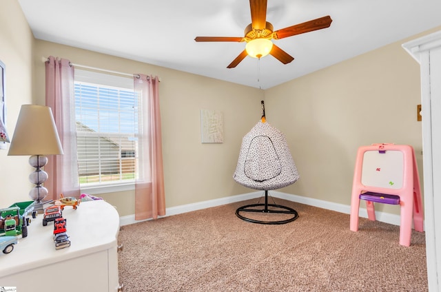 game room with carpet, baseboards, and a ceiling fan