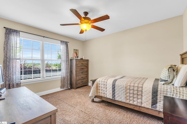 bedroom featuring baseboards, carpet floors, and a ceiling fan