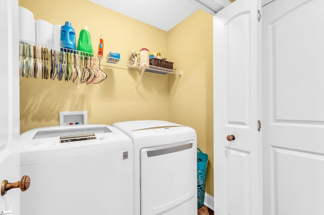 clothes washing area featuring washer and dryer