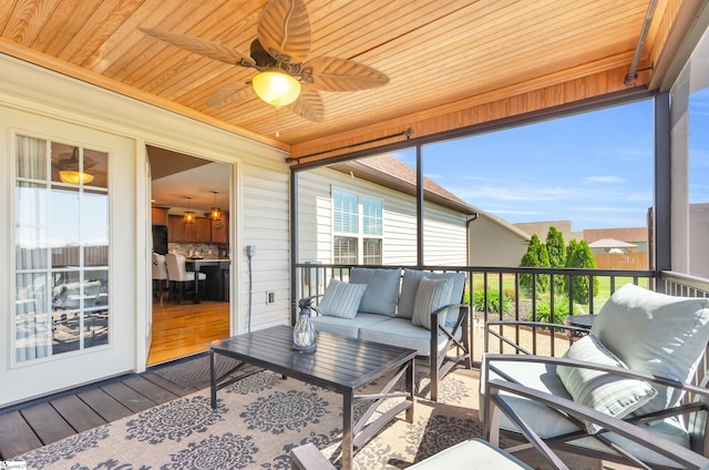 sunroom featuring an outdoor living space and ceiling fan