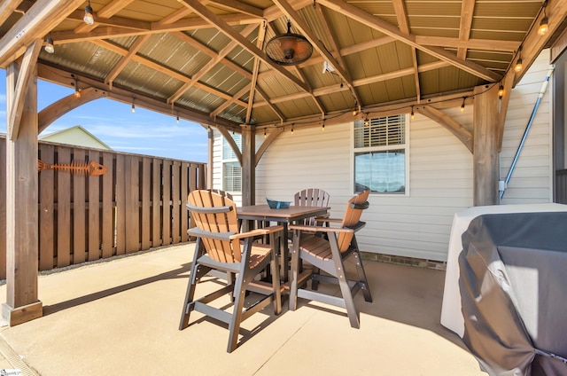 view of patio / terrace with a gazebo, outdoor dining area, grilling area, and fence