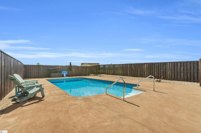 view of swimming pool featuring a fenced backyard and a patio area