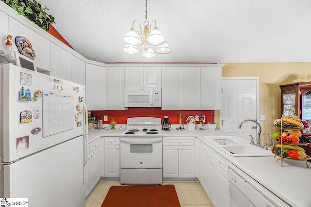 kitchen featuring a sink, light countertops, white appliances, and a chandelier