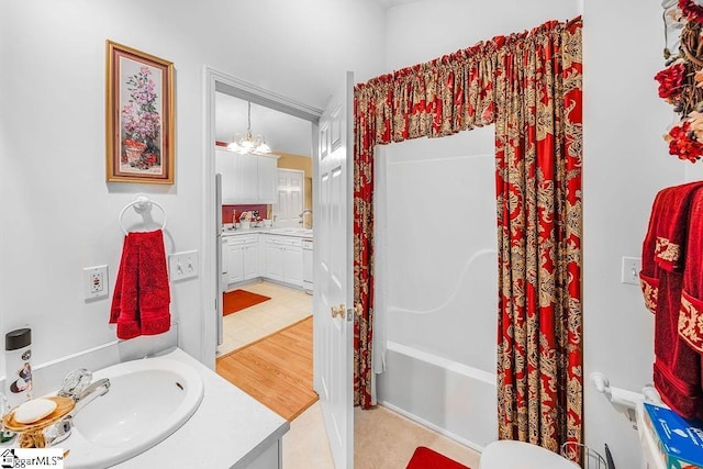full bath with tile patterned floors, vanity, and shower / bath combo with shower curtain