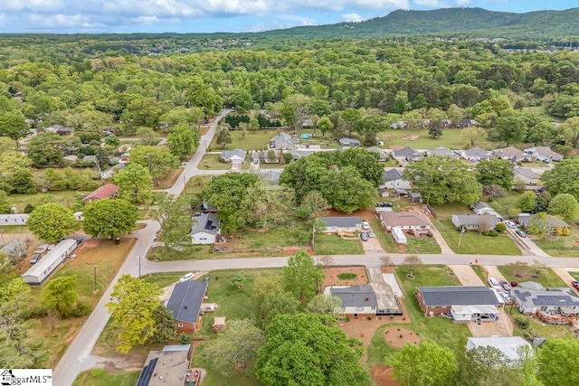 birds eye view of property featuring a forest view and a residential view