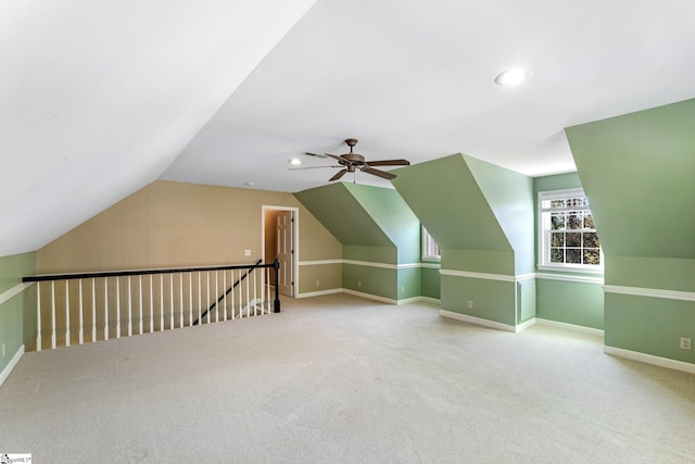 additional living space with ceiling fan, carpet, and lofted ceiling