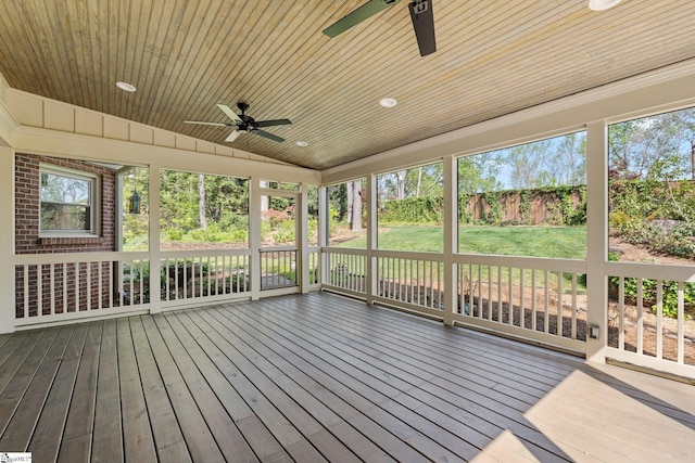 unfurnished sunroom featuring a ceiling fan