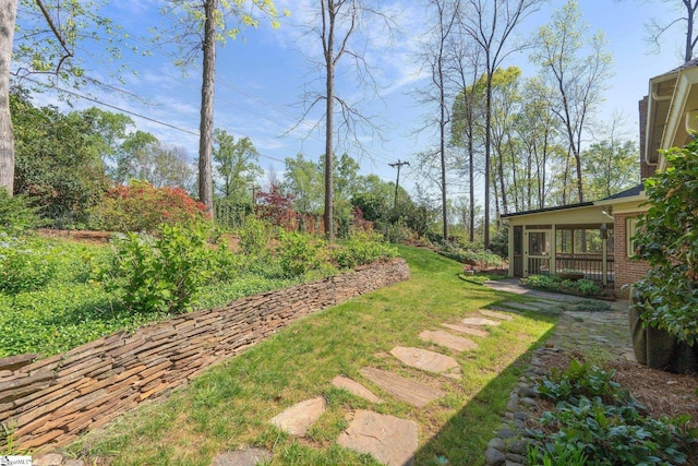 view of yard featuring a sunroom