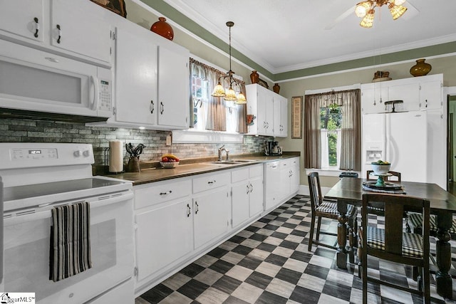 406 N Main St, Fountain Inn, SC 29644 - kitchen with white appliances, crown molding, dark countertops, a sink, and dark floors
