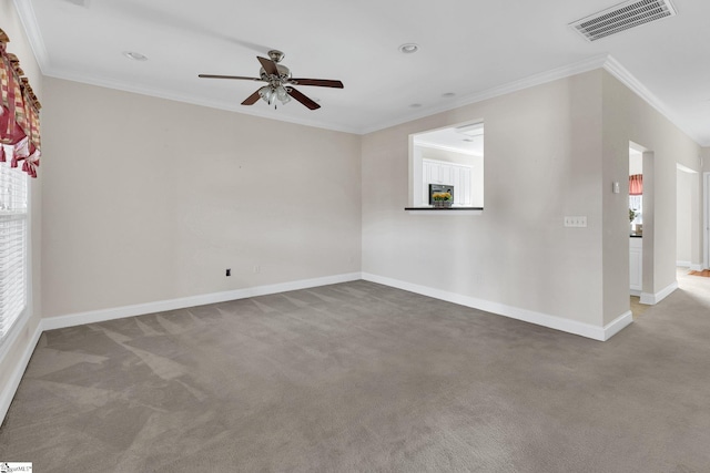 unfurnished room with visible vents, baseboards, ornamental molding, ceiling fan, and carpet floors