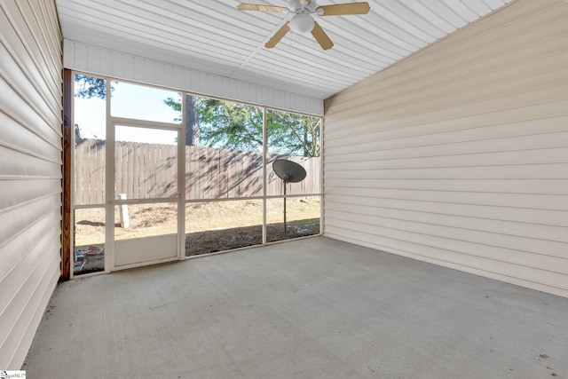 unfurnished sunroom featuring ceiling fan