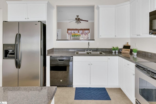 kitchen with a sink, dark countertops, a ceiling fan, white cabinetry, and stainless steel appliances