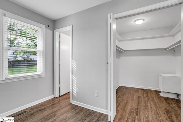 interior space with visible vents and wood finished floors