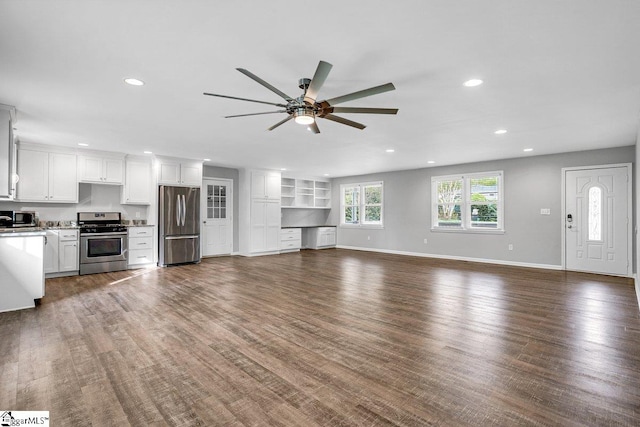 unfurnished living room featuring recessed lighting, baseboards, wood finished floors, and ceiling fan