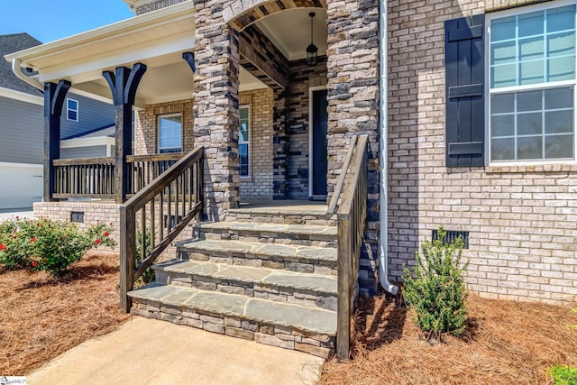 property entrance with brick siding and covered porch