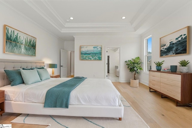 bedroom featuring a tray ceiling, crown molding, recessed lighting, and light wood-style flooring