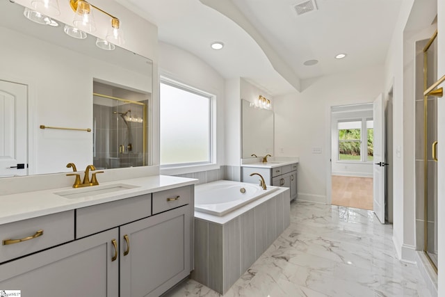 bathroom featuring a shower stall, a bath, visible vents, marble finish floor, and a sink