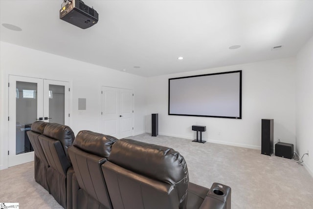 carpeted home theater featuring french doors, baseboards, and visible vents