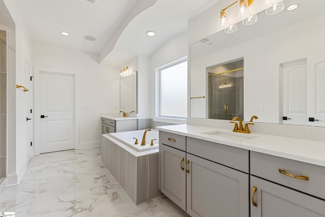 bathroom with a garden tub, a shower stall, recessed lighting, marble finish floor, and a sink