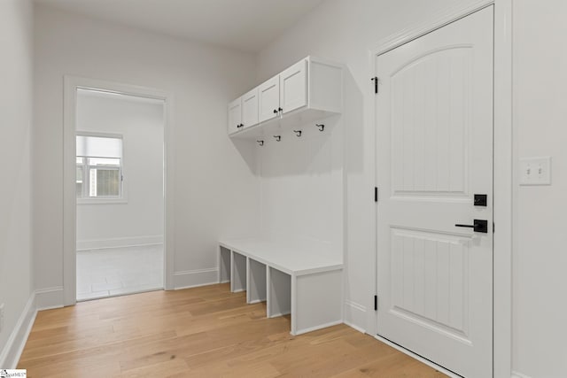 mudroom featuring light wood-style floors and baseboards